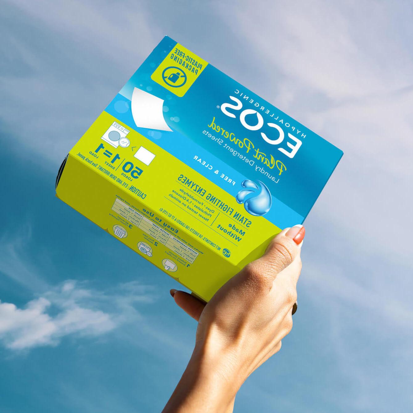 Hand holding ECOS laundry detergent sheets