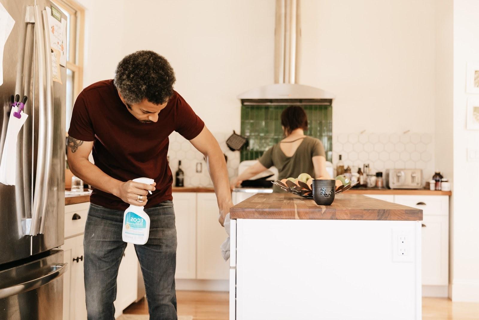 Man Cleaning Kitchen With Fragrance Free Disinfectant
