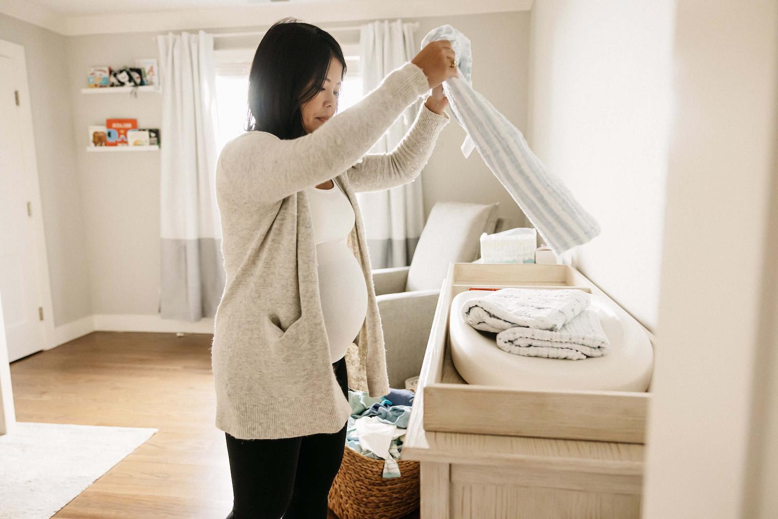 Pregnant Woman Folding Laundry