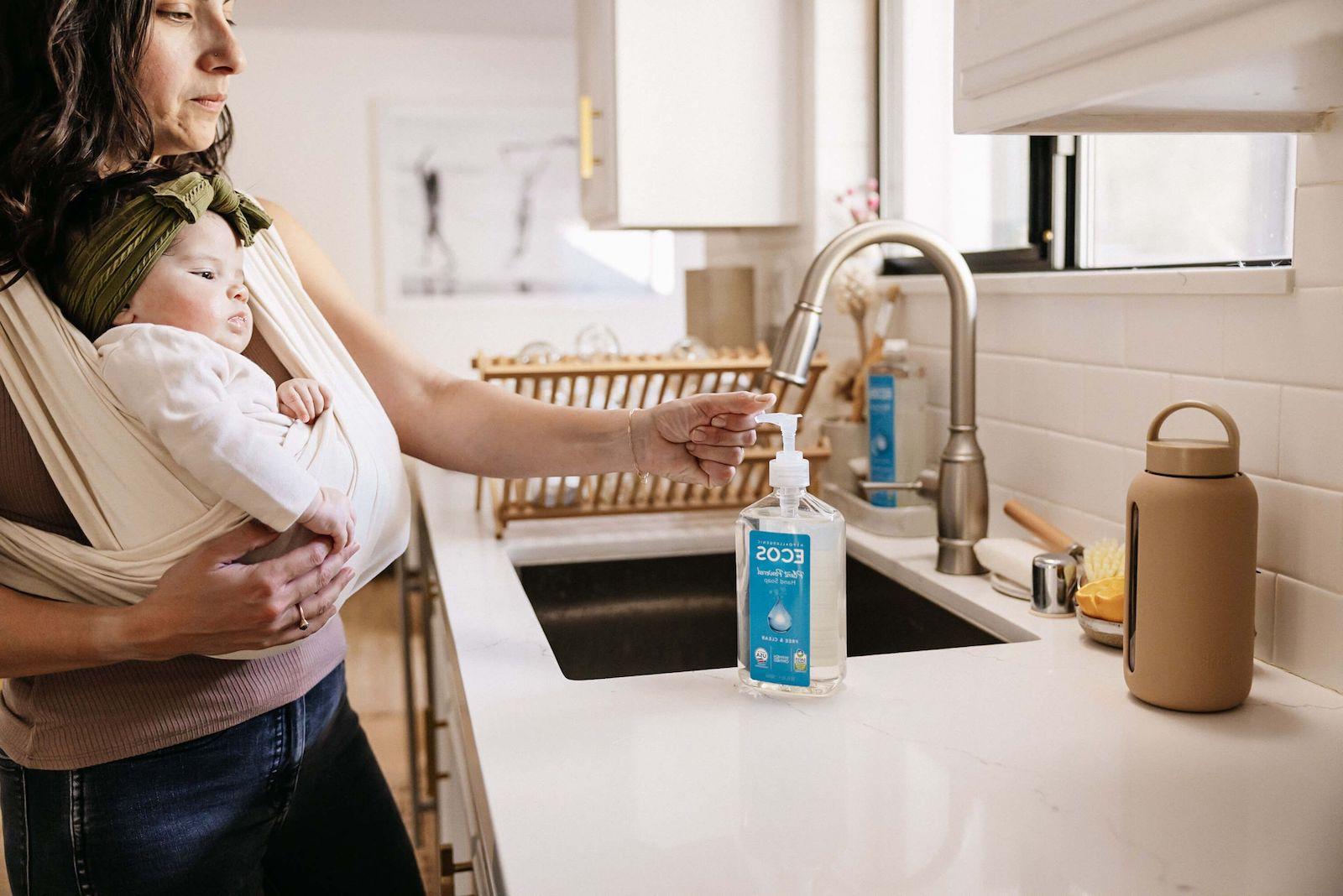 Mother Using Hand Soap With Baby