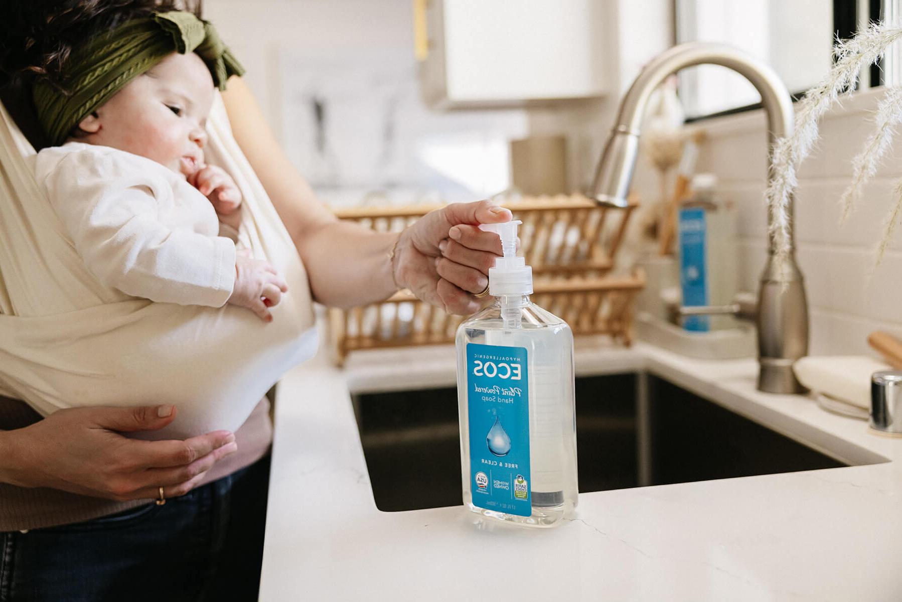 Woman holding baby using ECOS hand soap
