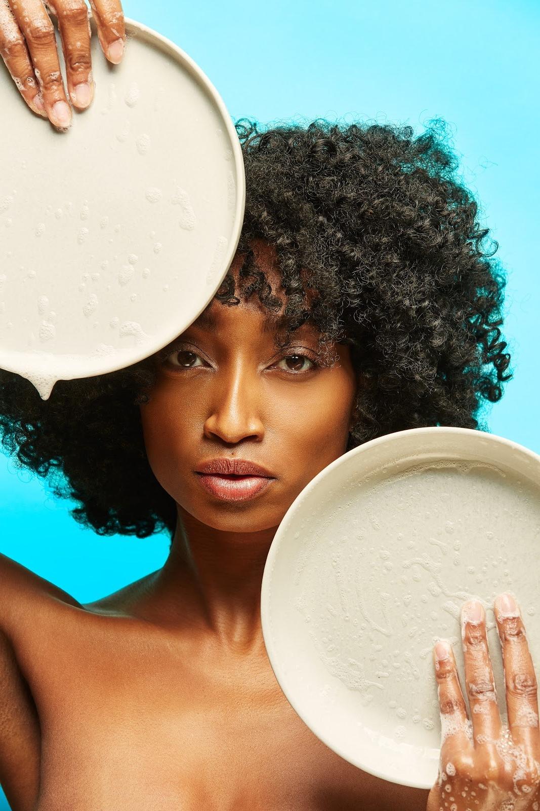 Woman Holding Up Two Soapy Plates