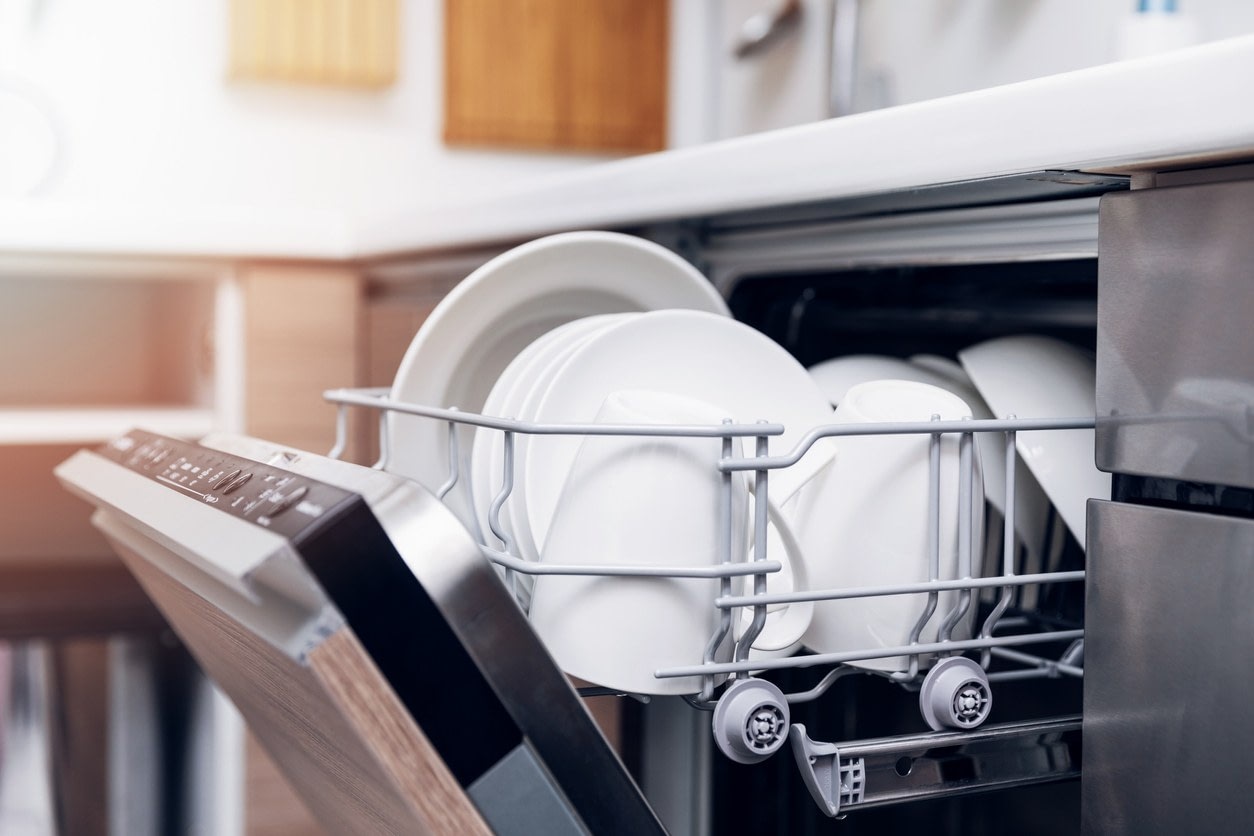 An open dish washer with clean dishes