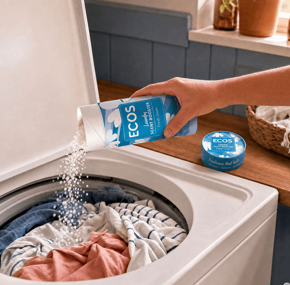 Woman pouring ECOS laundry scent booster into a washing machine full of dirty clothes.