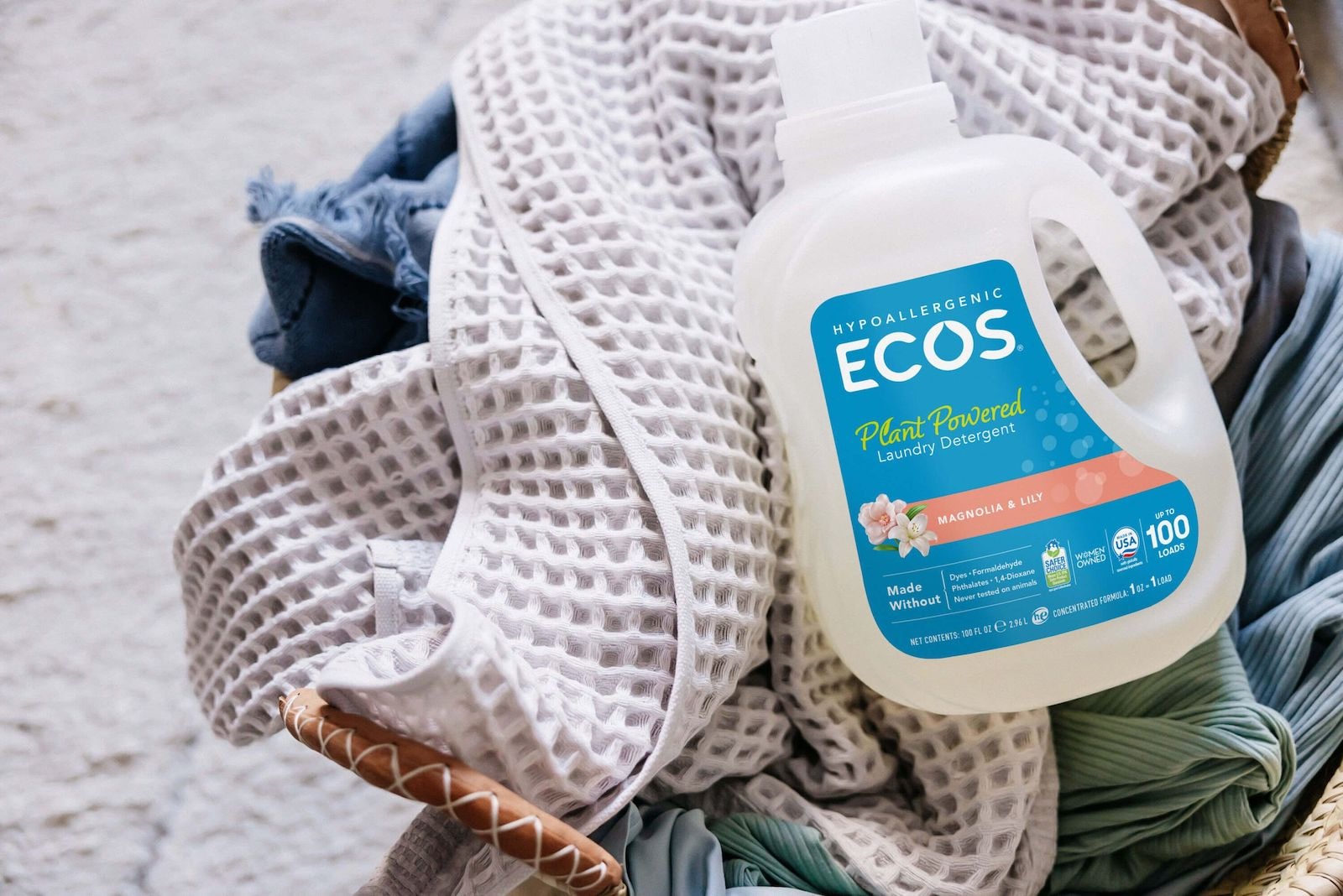 ECOS Magnolia Lily Liquid Detergent on Top of Dirty Laundry.