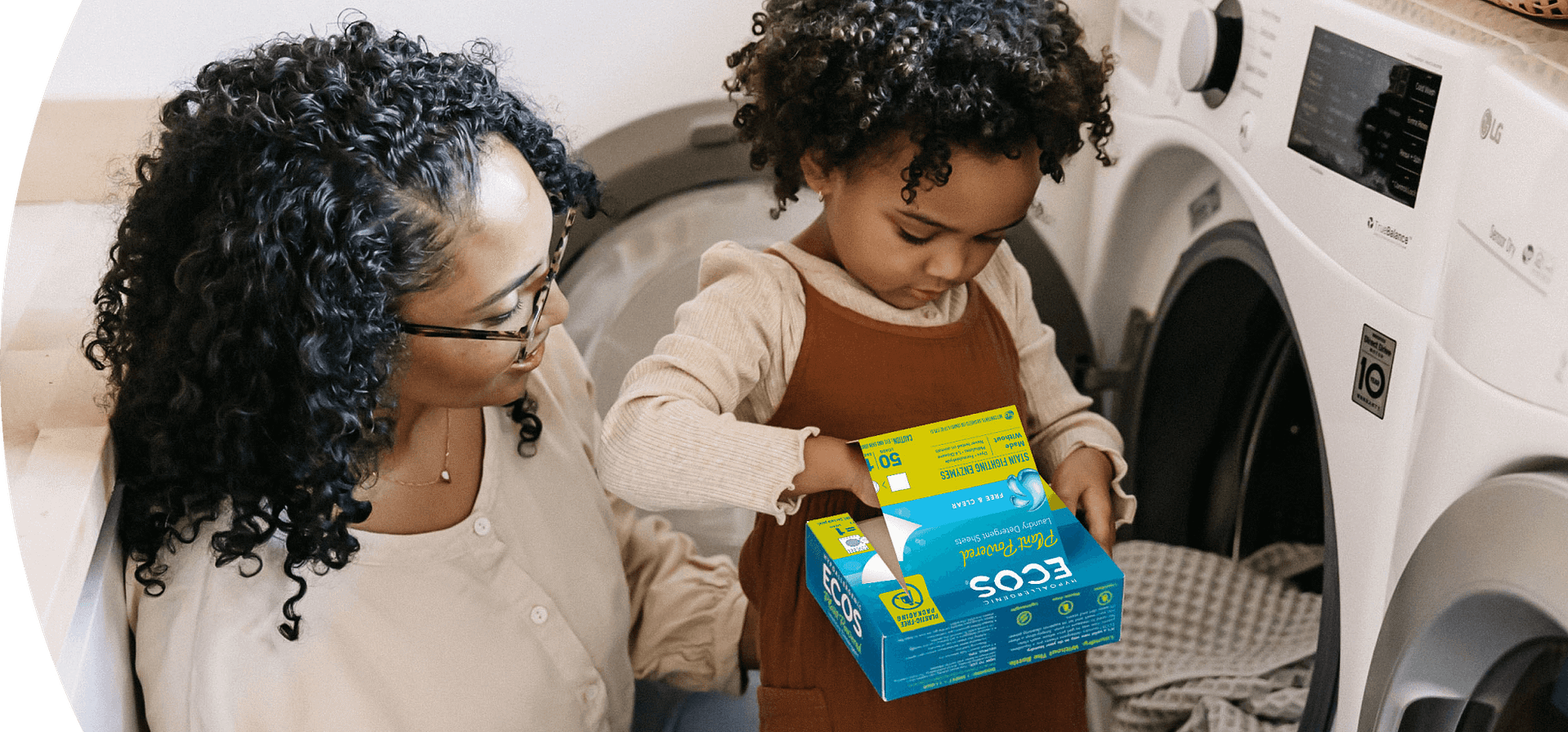 Woman and her child doing laundry using ECOS laundry strips Free & Clear